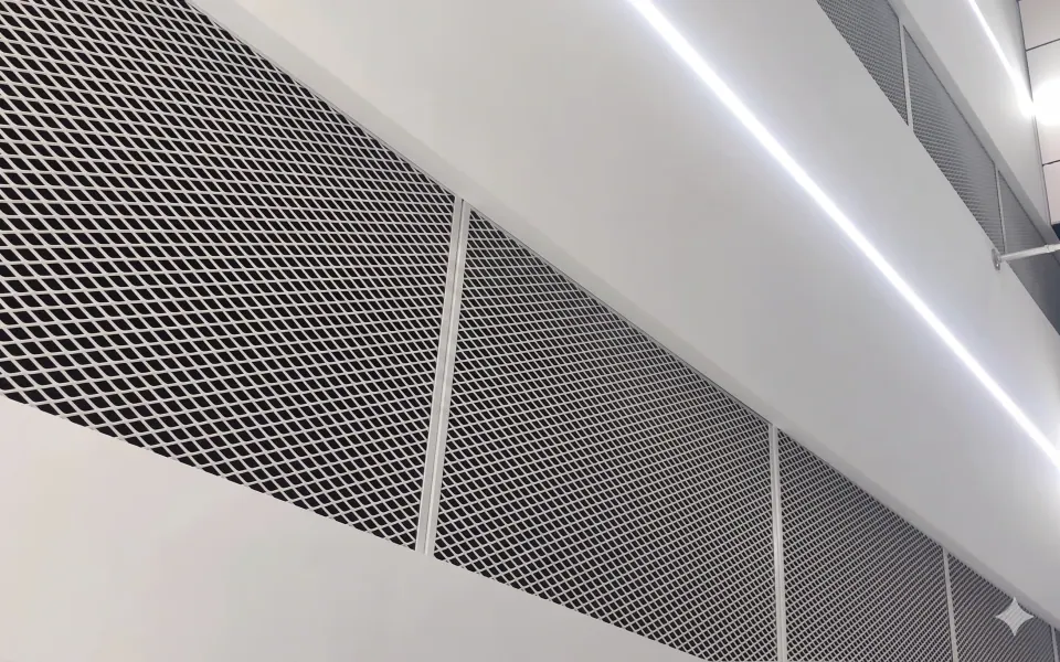 White architectural expanded metal screen panels in an interior corridor