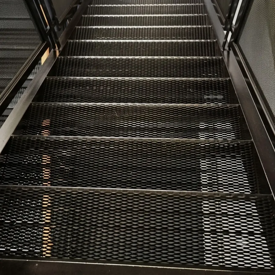 Black coated expanded metal stair treads installed indoors