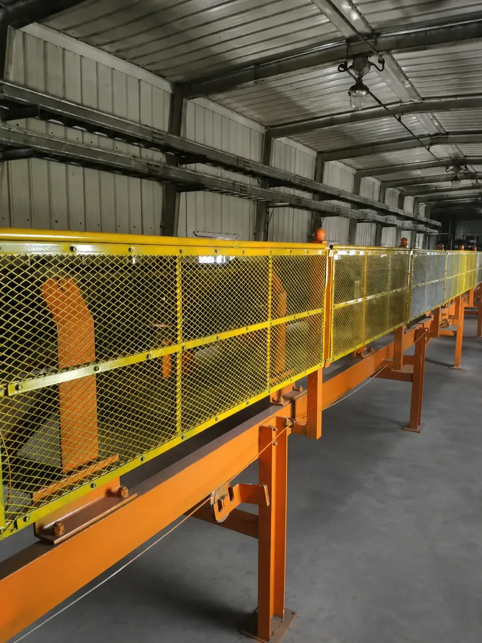 Expanded metal conveyor guard panels in a factory
