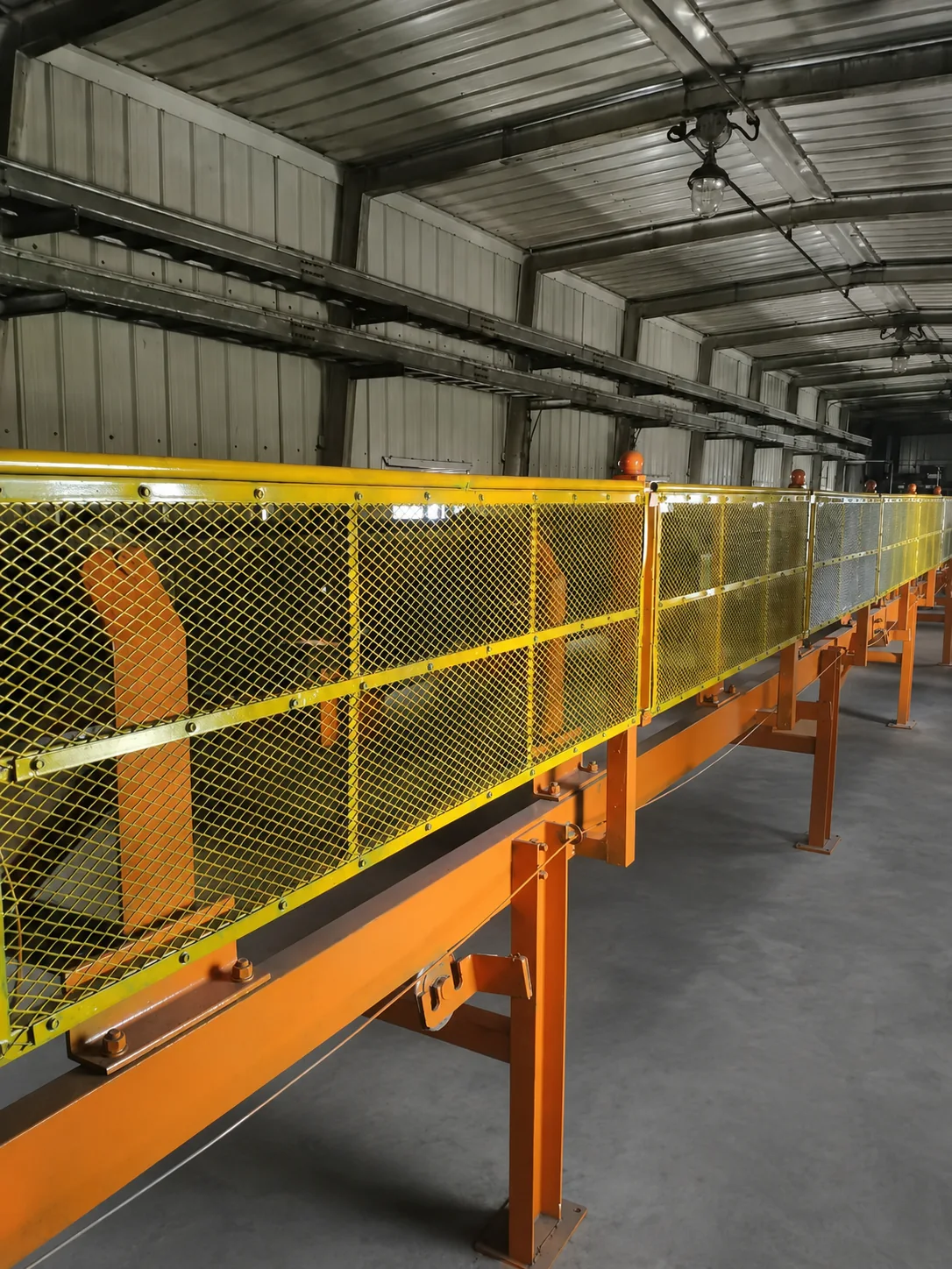 Expanded metal conveyor guard panels in a factory