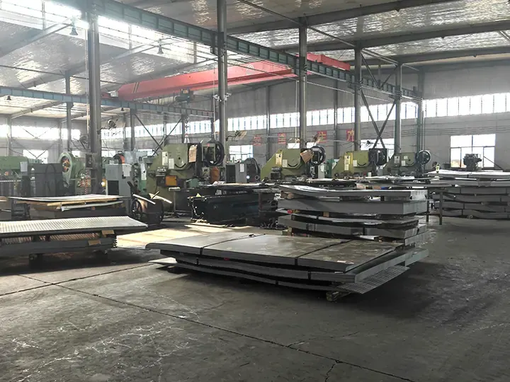 Expanded metal factory workshop with multiple press lines and sheet stock