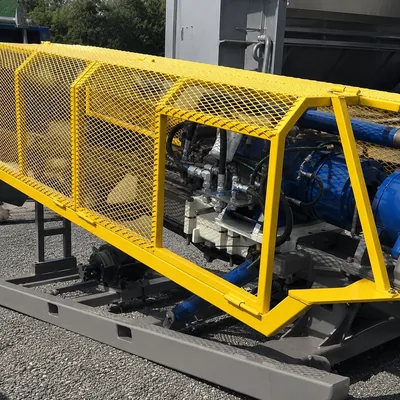 Yellow powder-coated expanded metal machine guard around industrial equipment