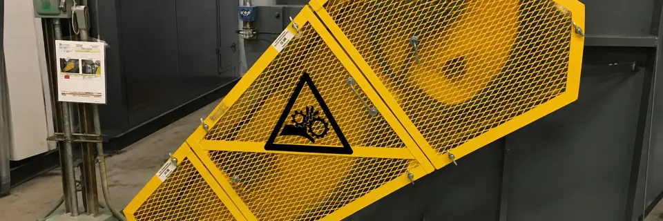 Yellow expanded metal guard panel on industrial equipment