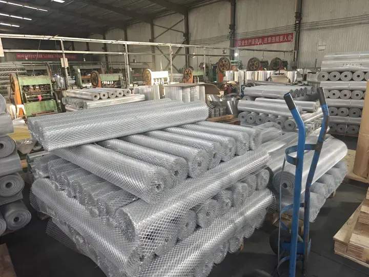 Expanded metal mesh rolls and finished stock inside the production workshop