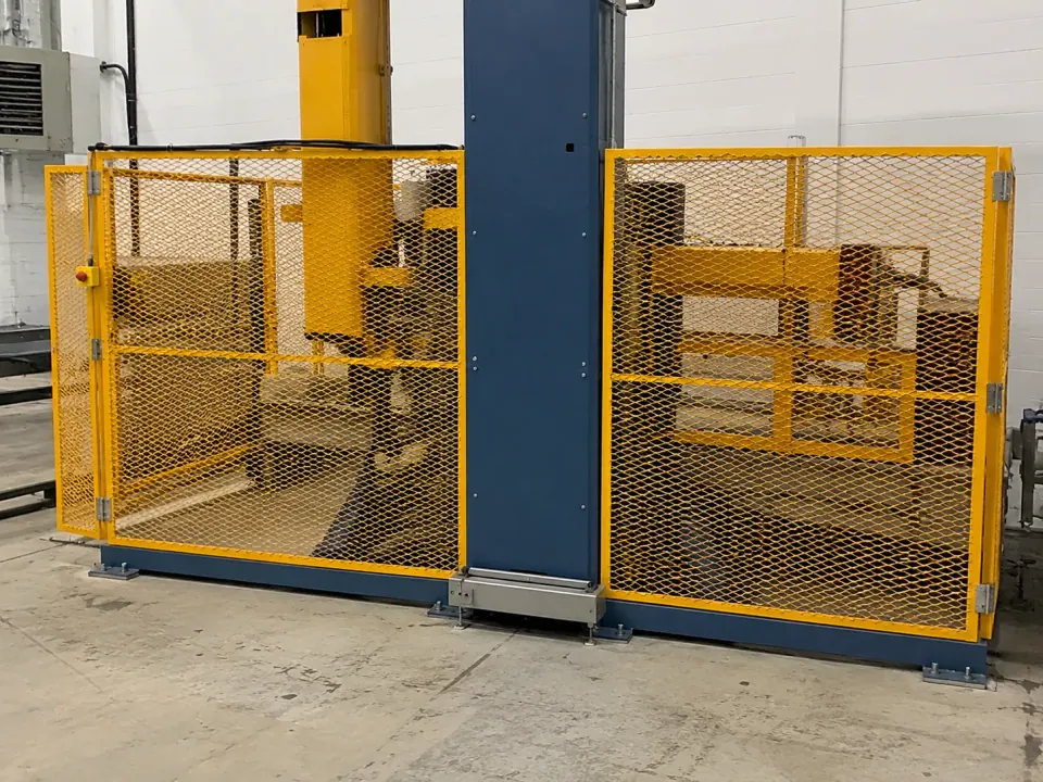 Yellow expanded metal guarding around an industrial robotic cell