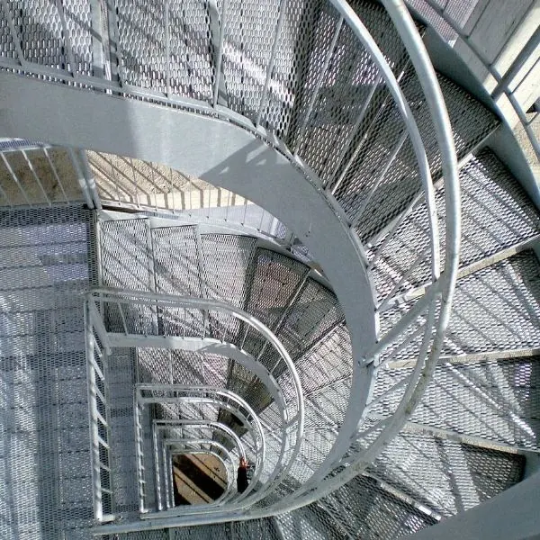 Galvanized expanded metal stair treads on a spiral industrial stair