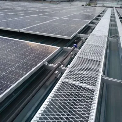 Galvanized expanded metal walkway and industrial access flooring beside solar panels