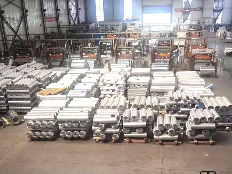 Expanded metal factory floor with production equipment and stored mesh rolls
