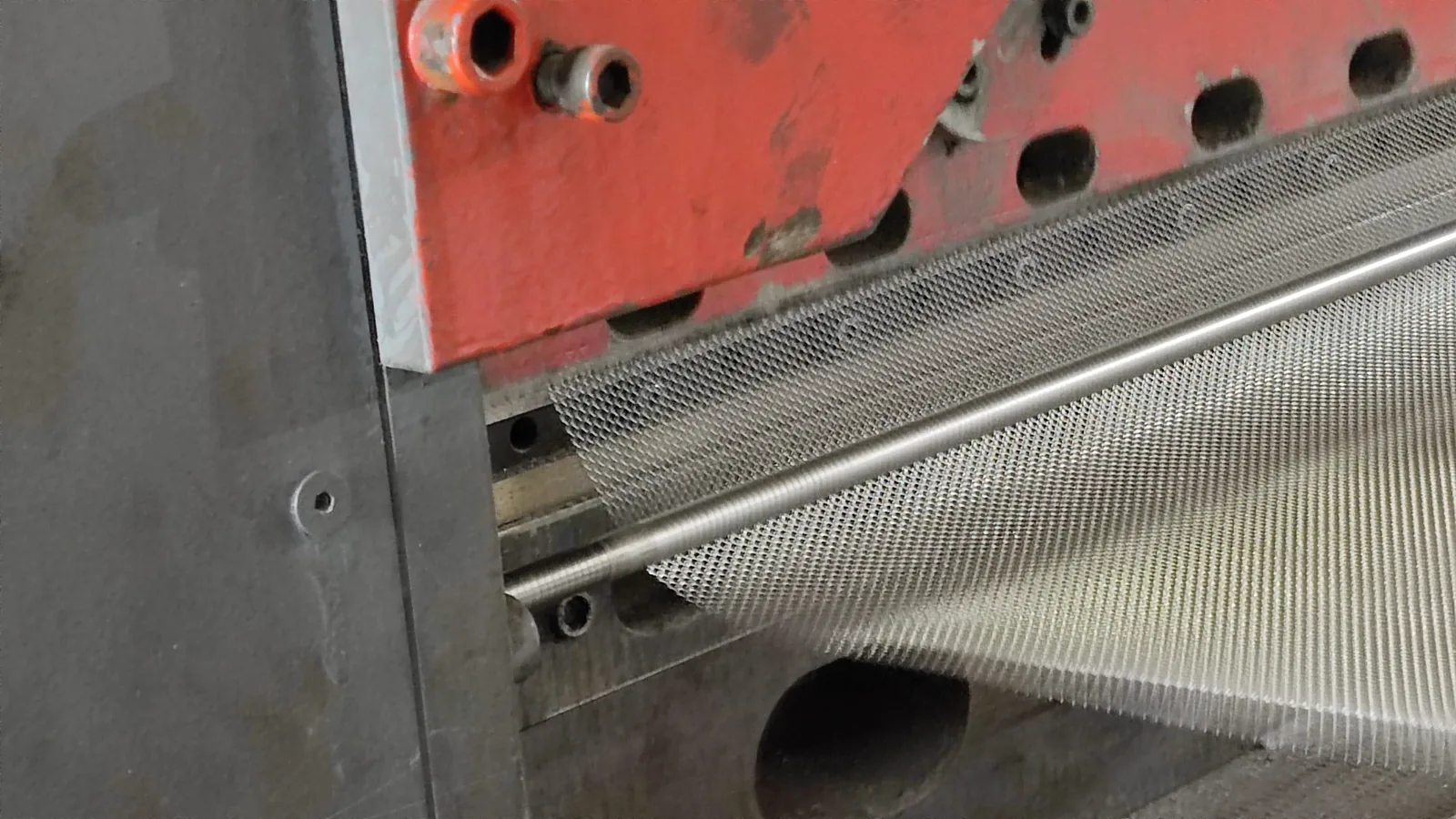 Close view of expanded metal mesh leaving the production machine