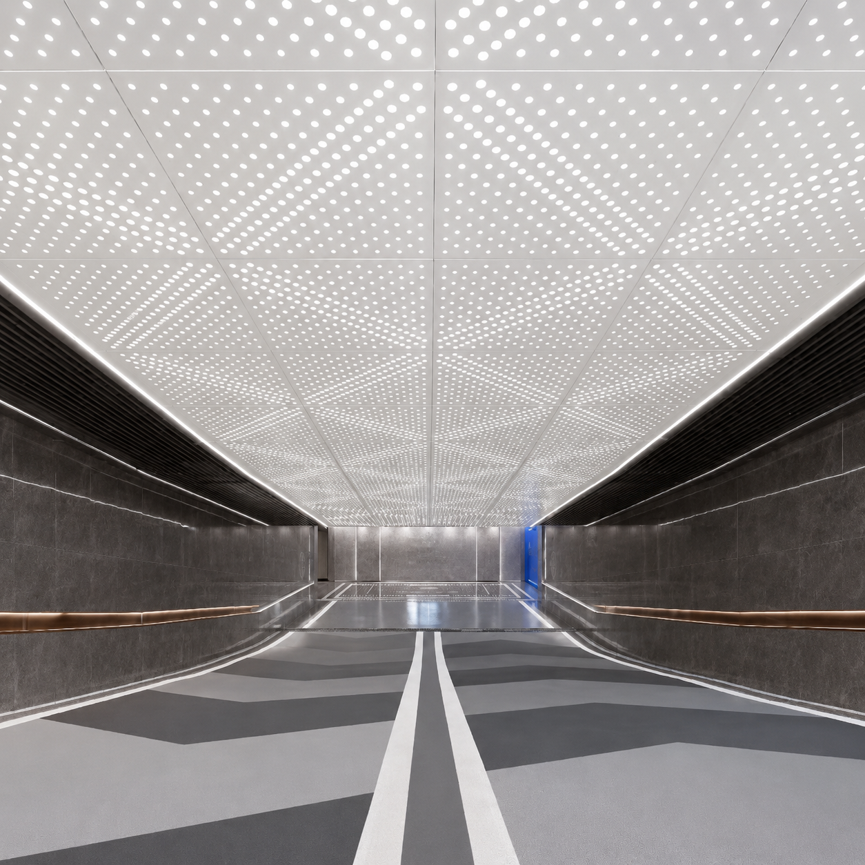 Aluminium perforated ceiling panels in a modern underground passage