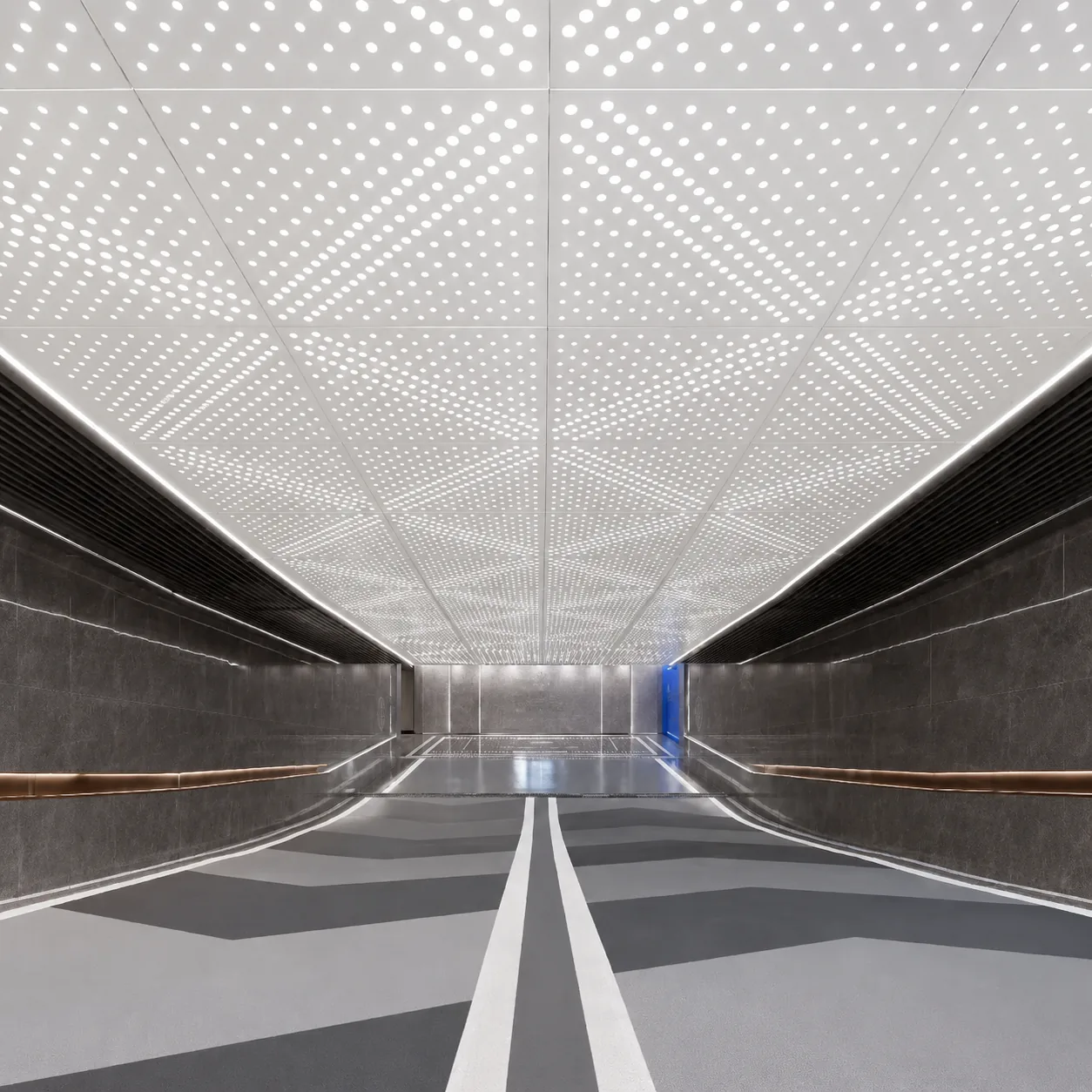 Aluminium perforated ceiling panels in a modern underground passage