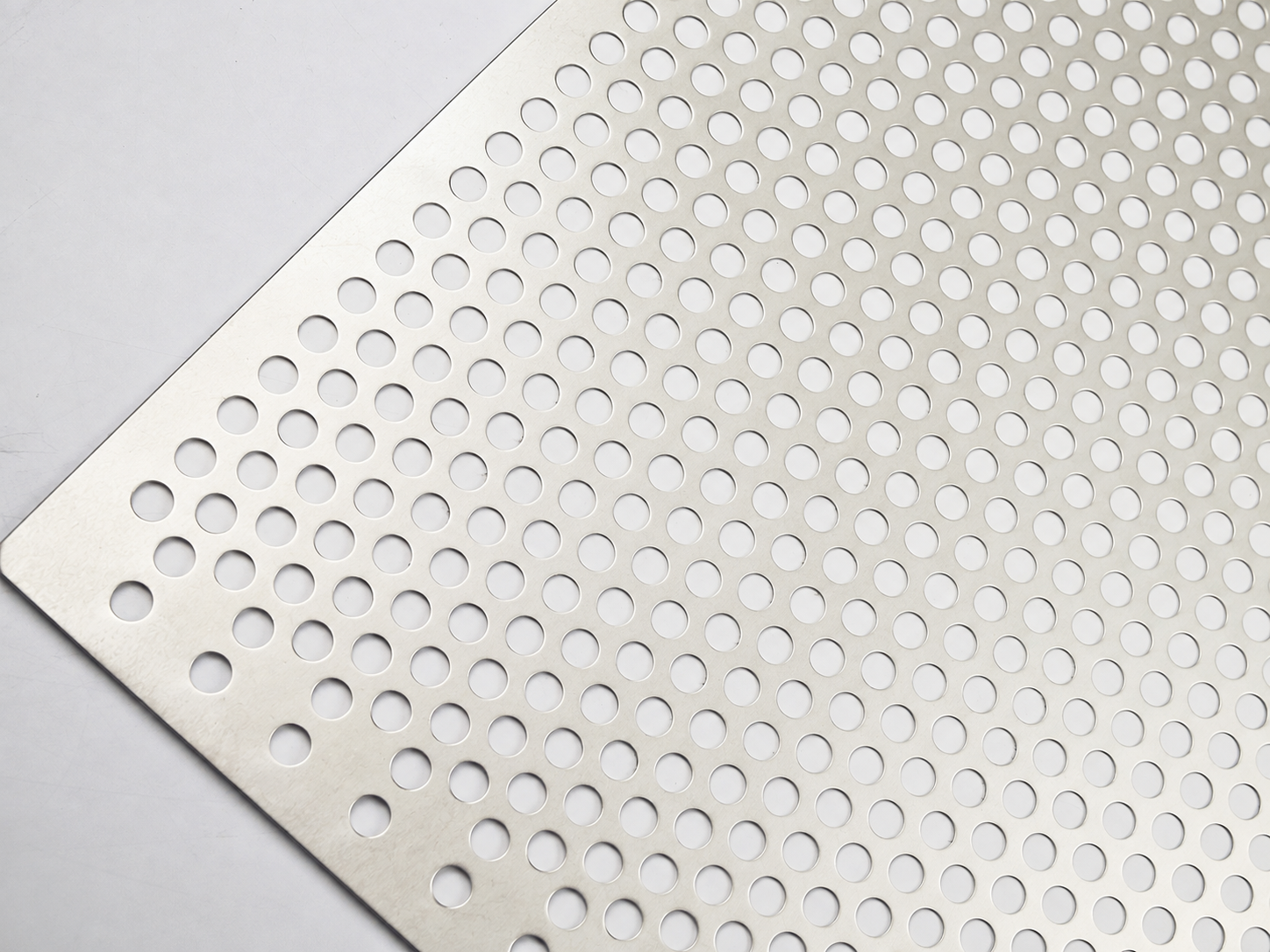 Close-up of nickel perforated sheet with round holes