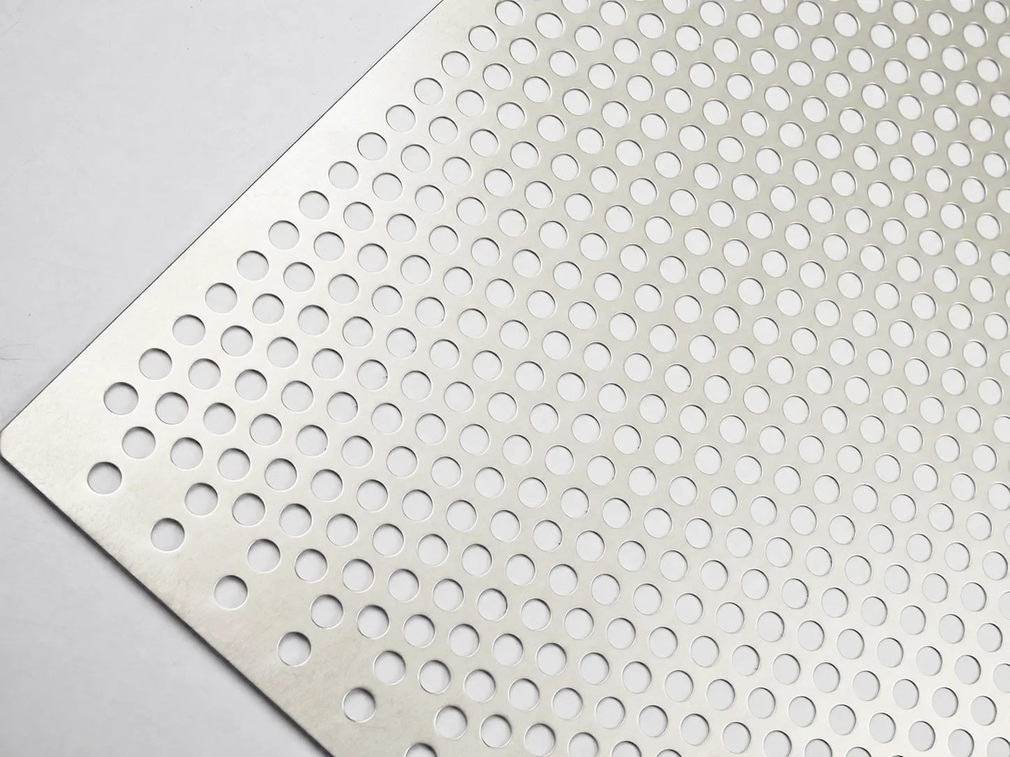 Close-up of nickel perforated sheet with round holes