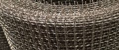 Close-up of crimped wire intersections and cut edges on stainless steel mesh rolls