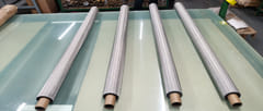 Four rolls of 304 stainless steel fine wire mesh on a factory inspection table